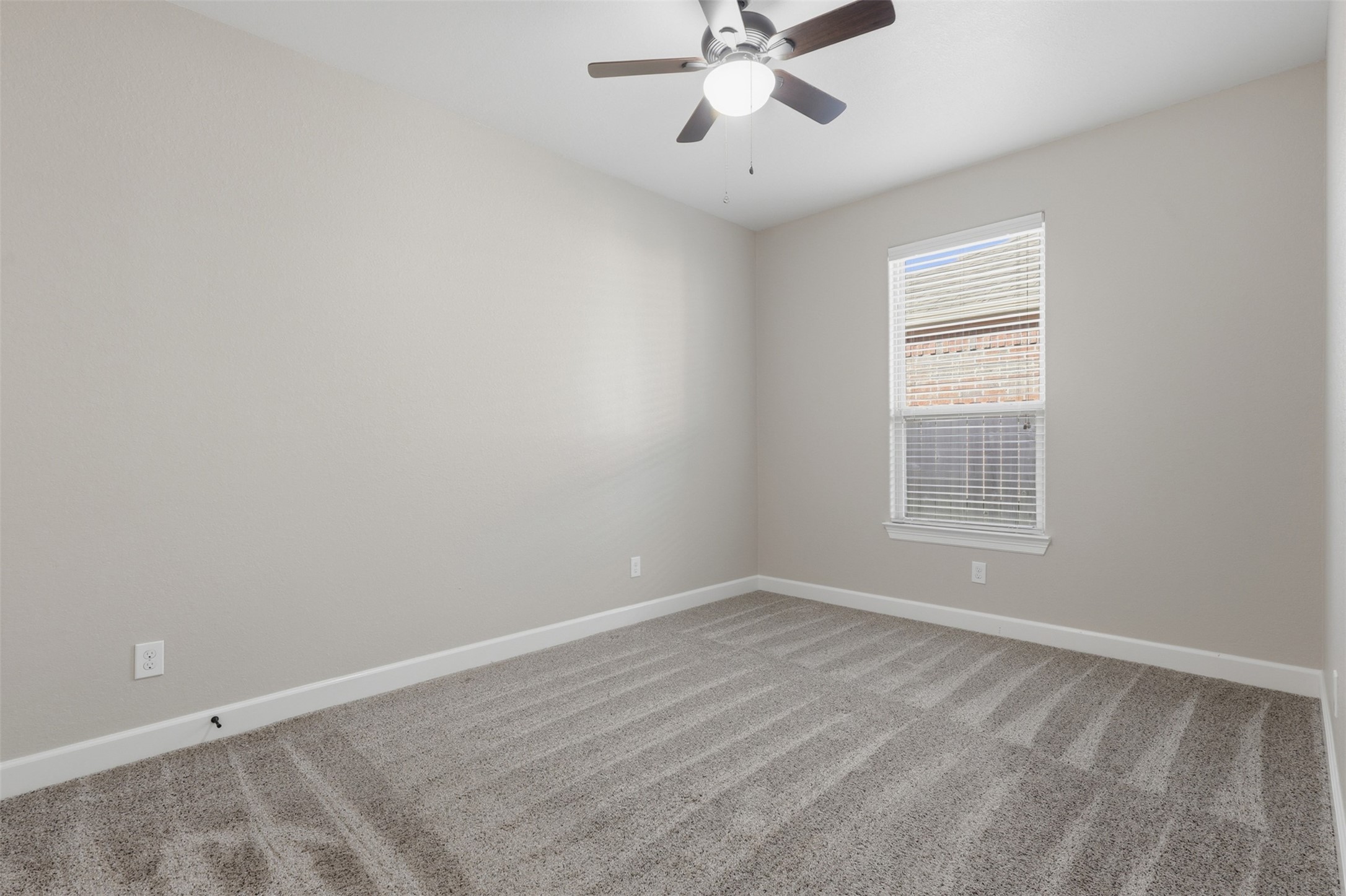 721 Rufina Street League City, TX 77573 - Photo 17 of 33 This inviting secondary bedroom offers plush new carpeting, a ceiling fan, and a bright window that fills the room with natural light. The comfortable layout provides an ideal setting for family, guests, or a quiet home office.