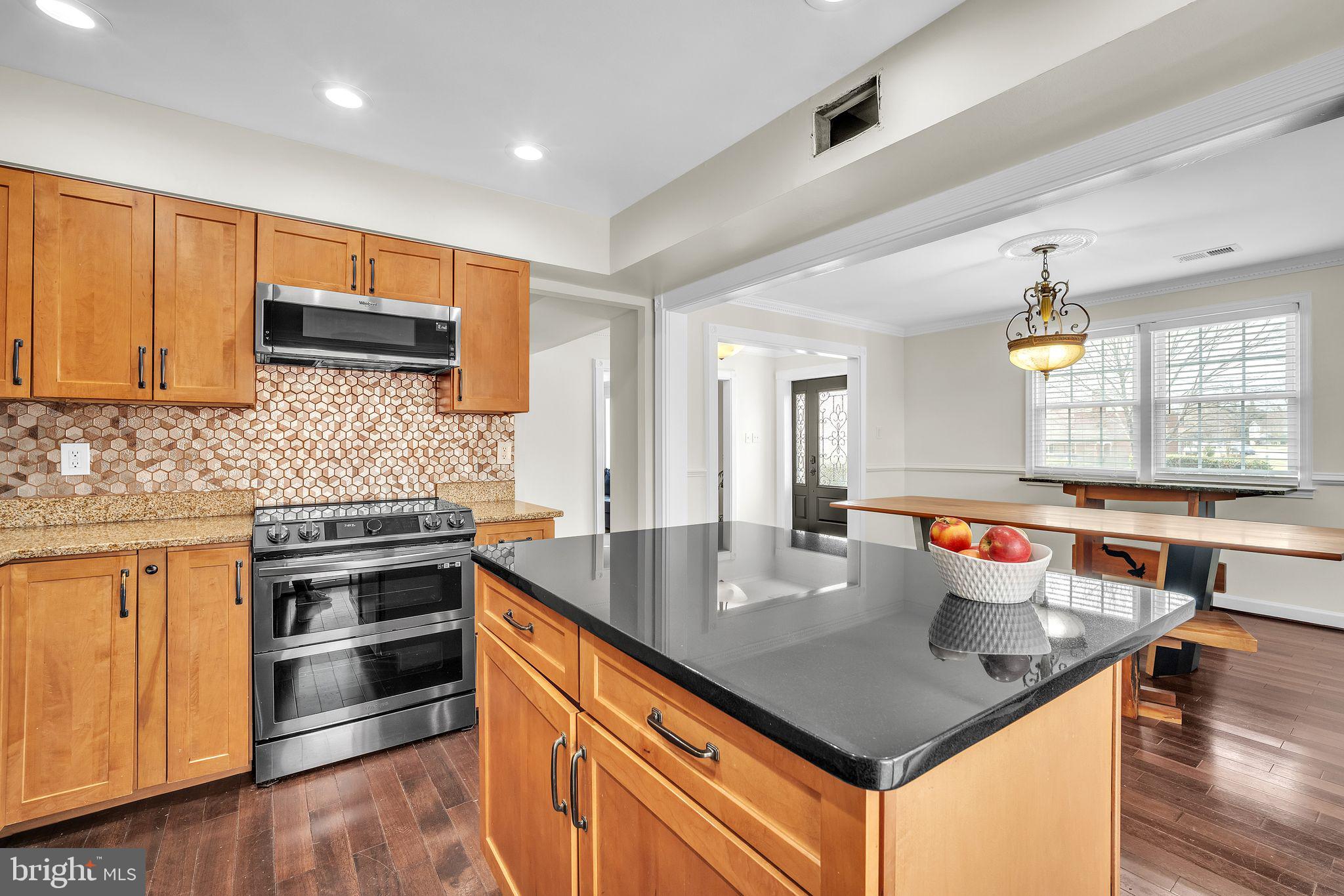 5255 Pumphrey Drive Fairfax, VA 22032 - Photo 11 of 38 a kitchen with stainless steel appliances granite countertop a sink counter space and wooden floor