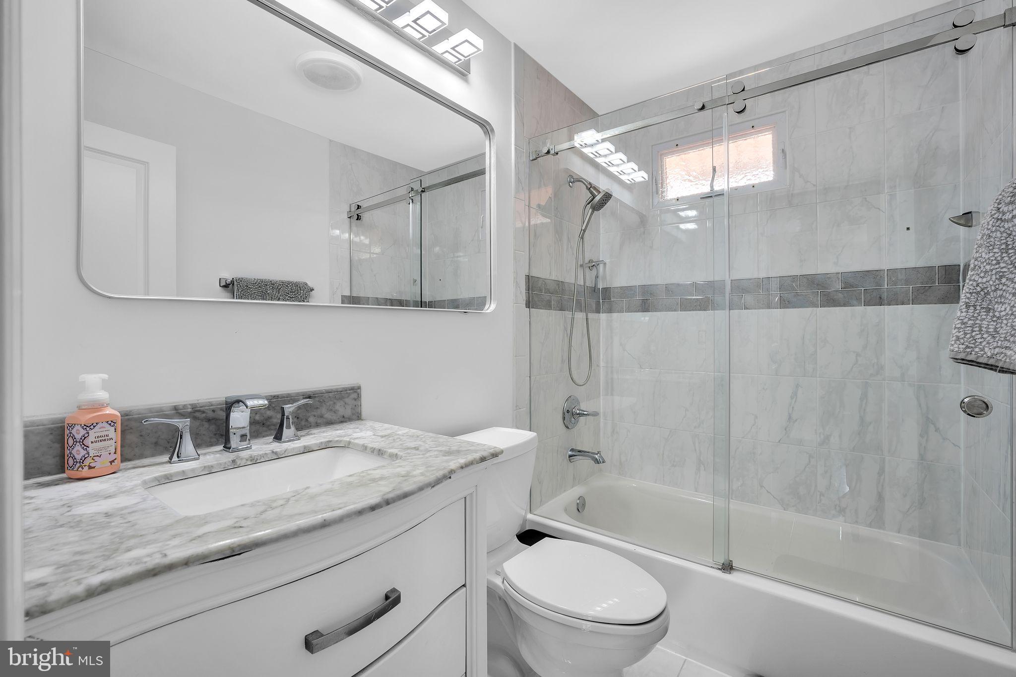 5255 Pumphrey Drive Fairfax, VA 22032 - Photo 16 of 38 a bathroom with a granite countertop sink a toilet and shower