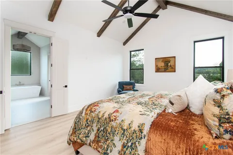 a bedroom with a bed and a couch