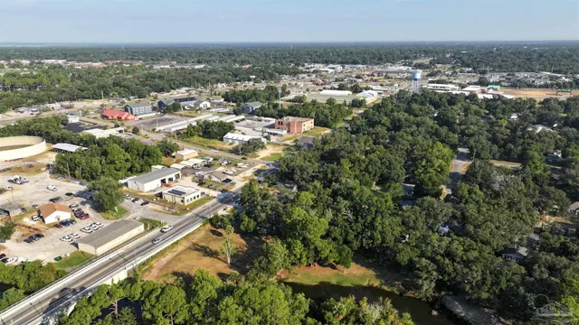 a view of swimming pool with outdoor seating and trees