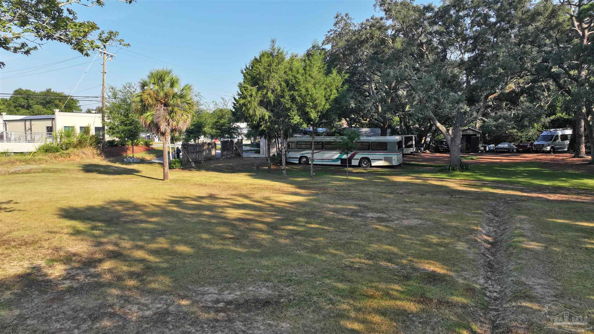610 South Old Corry Field Road Pensacola, FL 32507 - Photo 16 of 72 a view of swimming pool with outdoor seating and trees