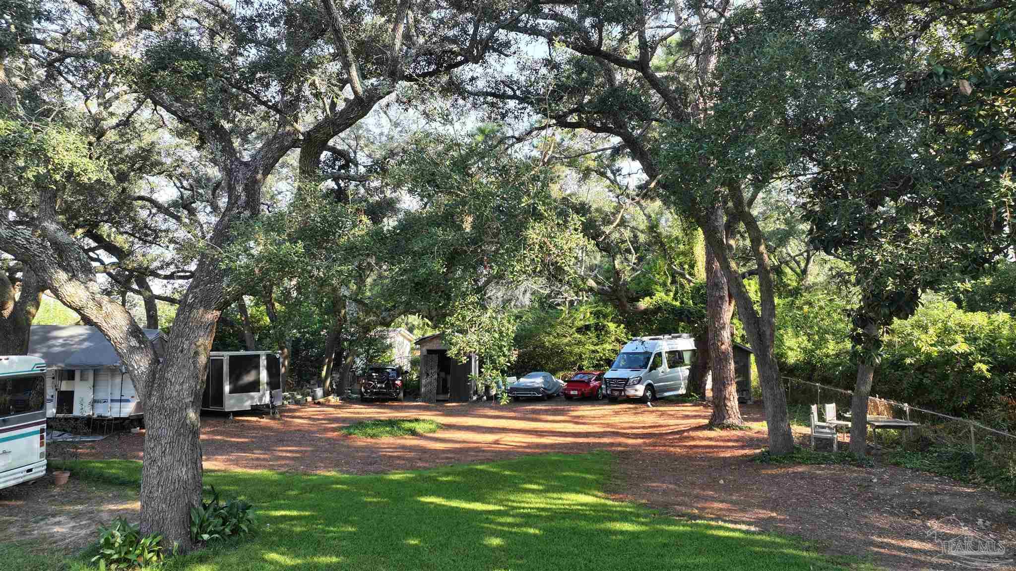 610 South Old Corry Field Road Pensacola, FL 32507 - Photo 17 of 72 a view of a trees in front of a house