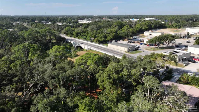 a view of a lake in between two trees