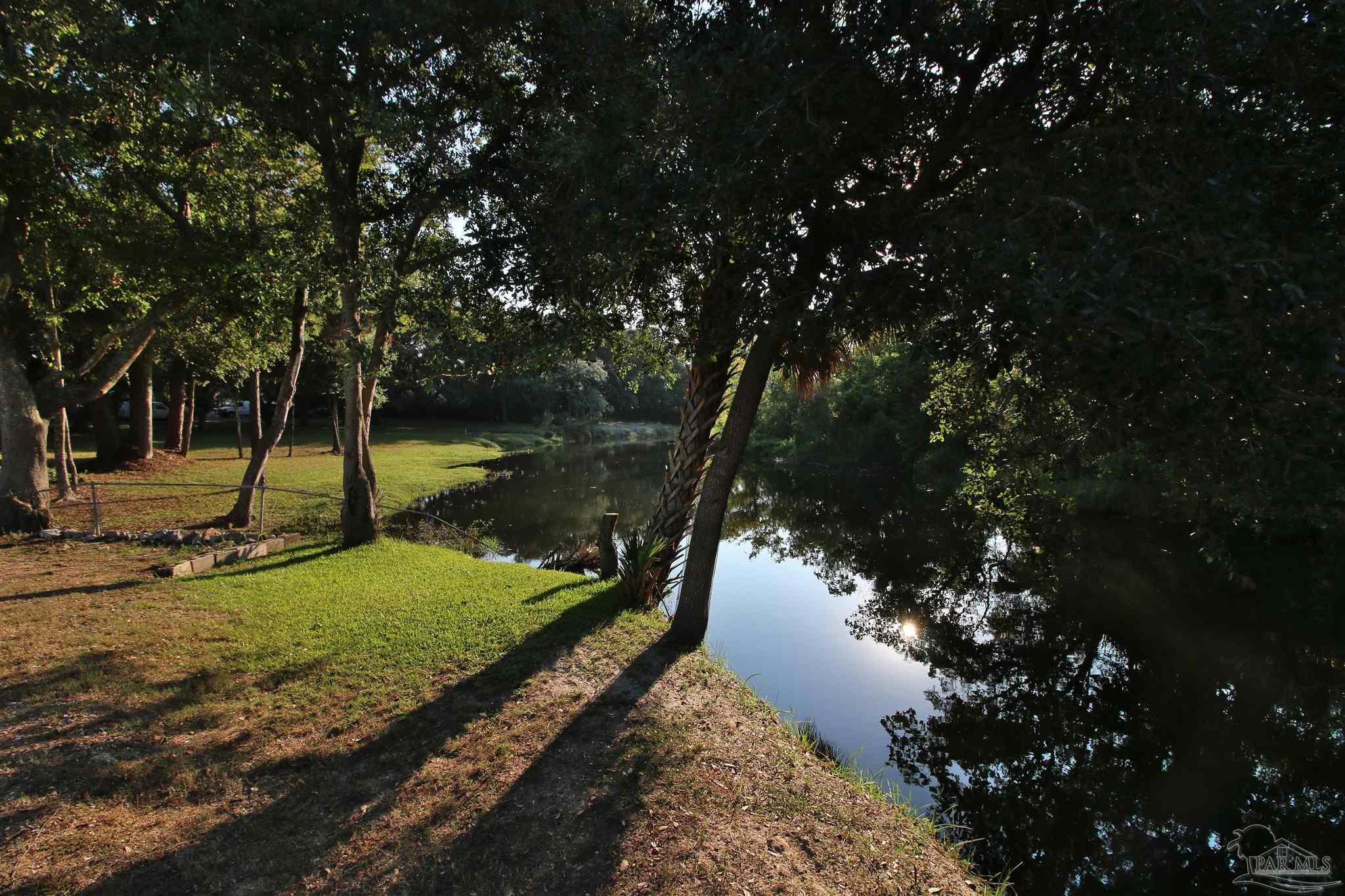610 South Old Corry Field Road Pensacola, FL 32507 - Photo 40 of 72 a view of a lake in between two trees