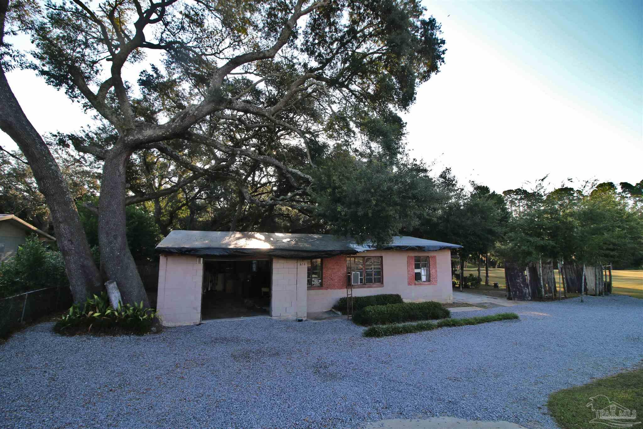 610 South Old Corry Field Road Pensacola, FL 32507 - Photo 49 of 72 a view of a house with a yard and large tree