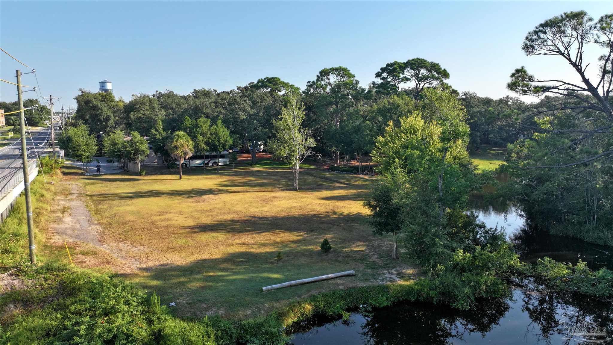 610 South Old Corry Field Road Pensacola, FL 32507 - Photo 8 of 72 a view of a swimming pool with a yard and plants