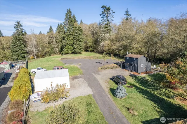 an aerial view of a house with yard swimming pool and outdoor seating