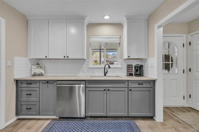 a kitchen with stainless steel appliances granite countertop a sink and cabinets
