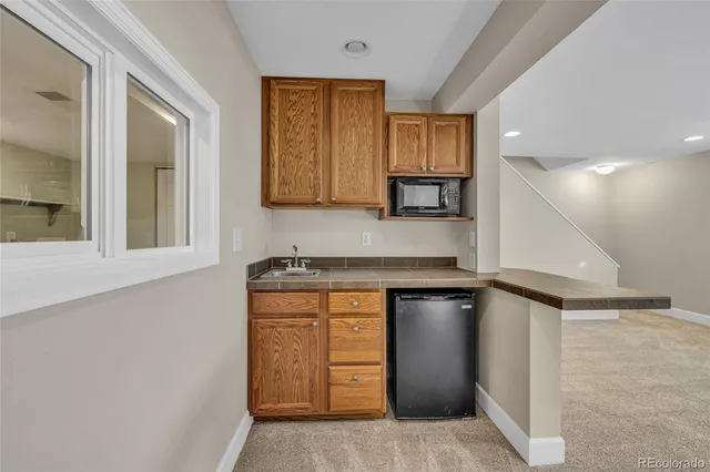 a kitchen with a refrigerator and a sink