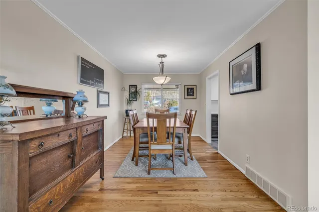 a view of a dining room with furniture window and wooden floor