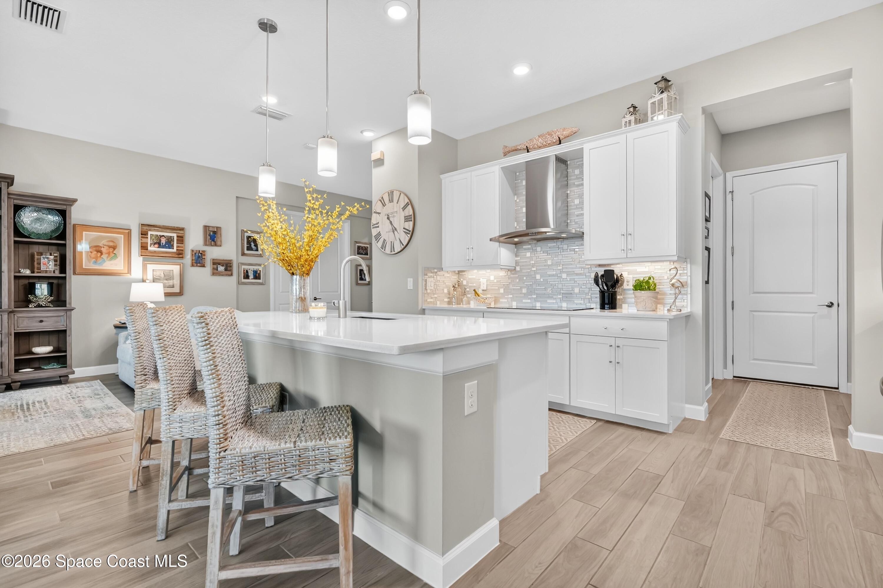 2819 Millennium Circle Melbourne, FL 32940 - Photo 10 of 39 a kitchen with kitchen island granite countertop a sink cabinets and wooden floor