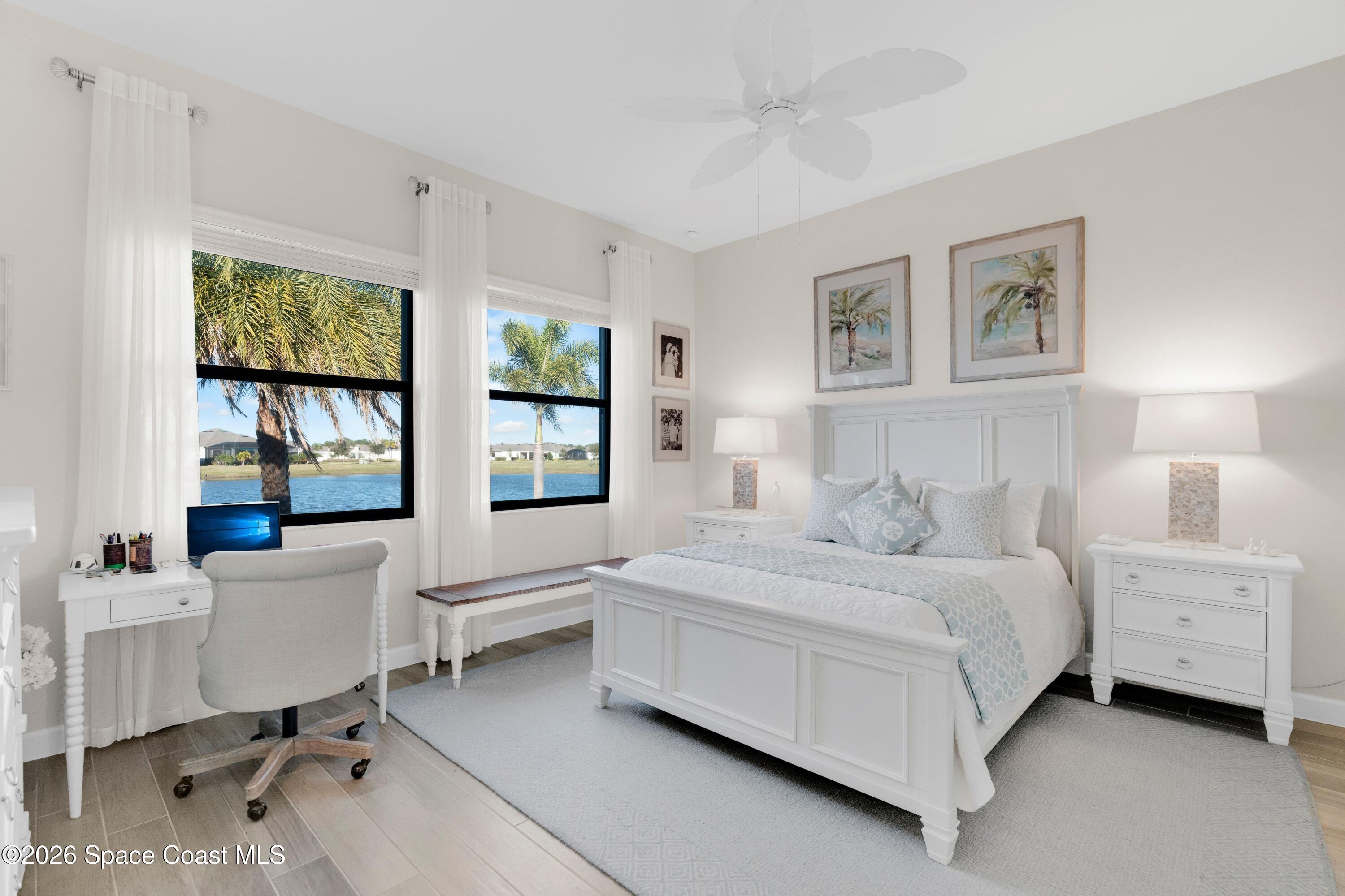 2819 Millennium Circle Melbourne, FL 32940 - Photo 13 of 39 a bedroom with a white bed and a desk