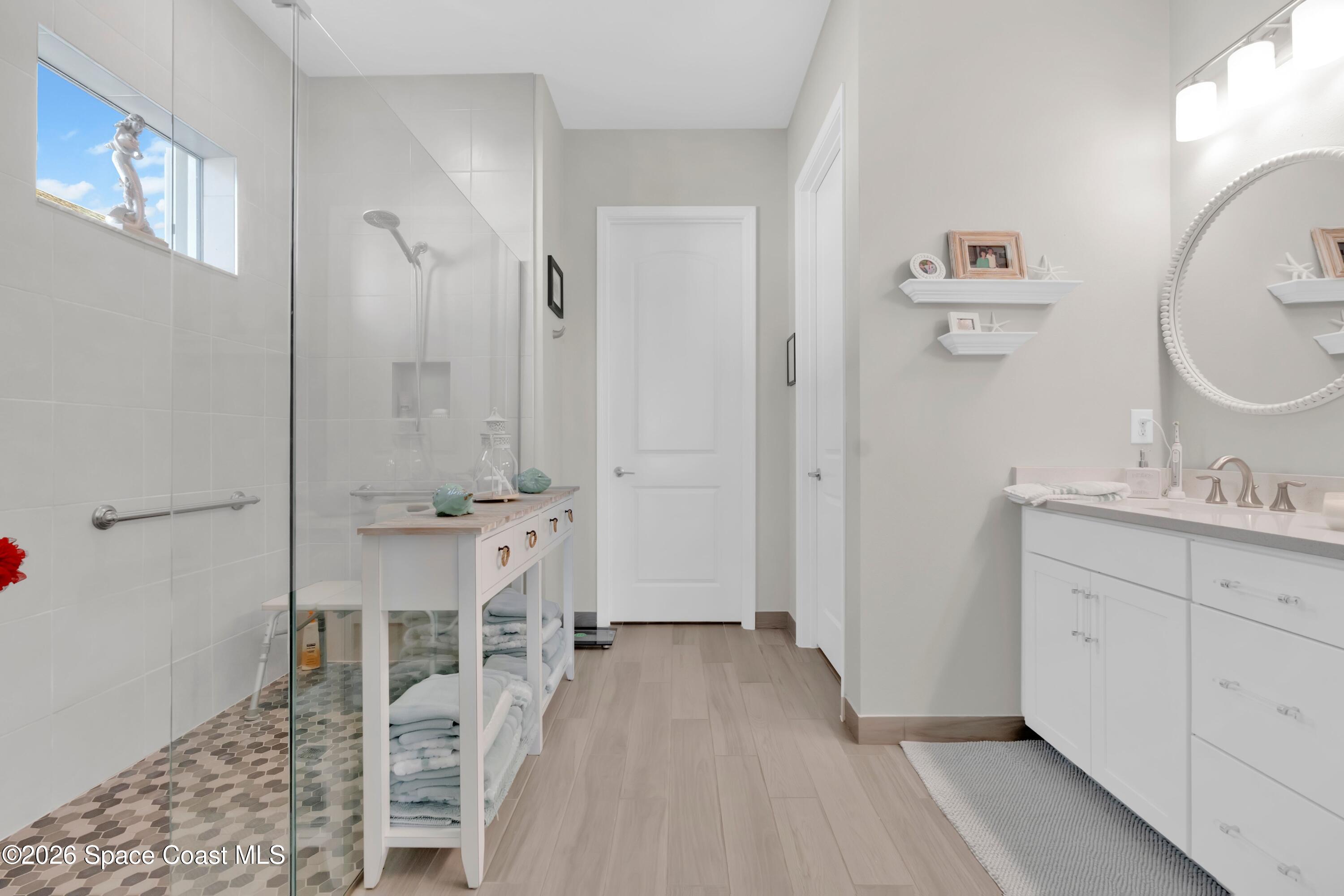 2819 Millennium Circle Melbourne, FL 32940 - Photo 14 of 39 a bathroom with a sink mirror and a shower