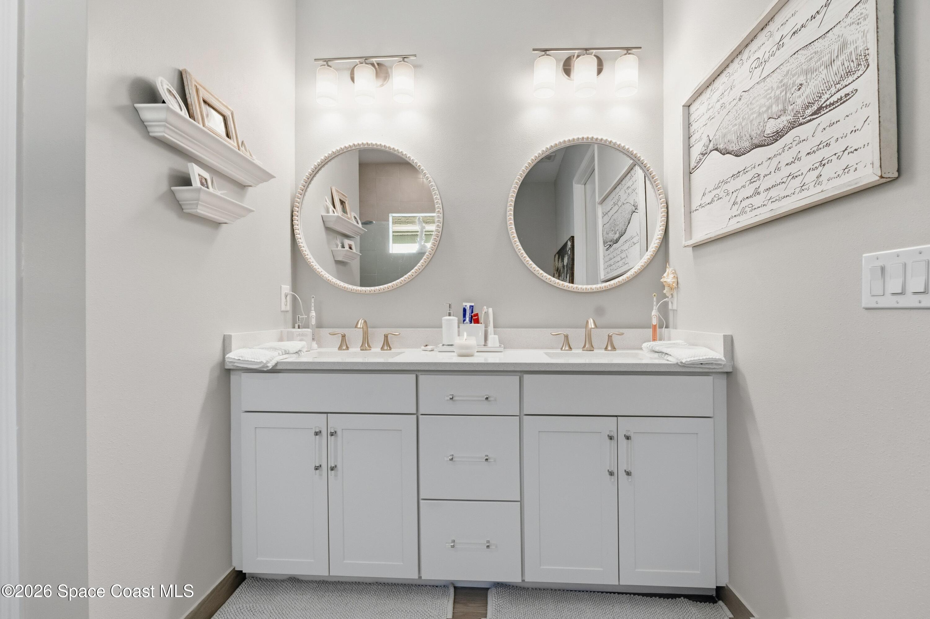 2819 Millennium Circle Melbourne, FL 32940 - Photo 15 of 39 a bathroom with a sink and a mirror