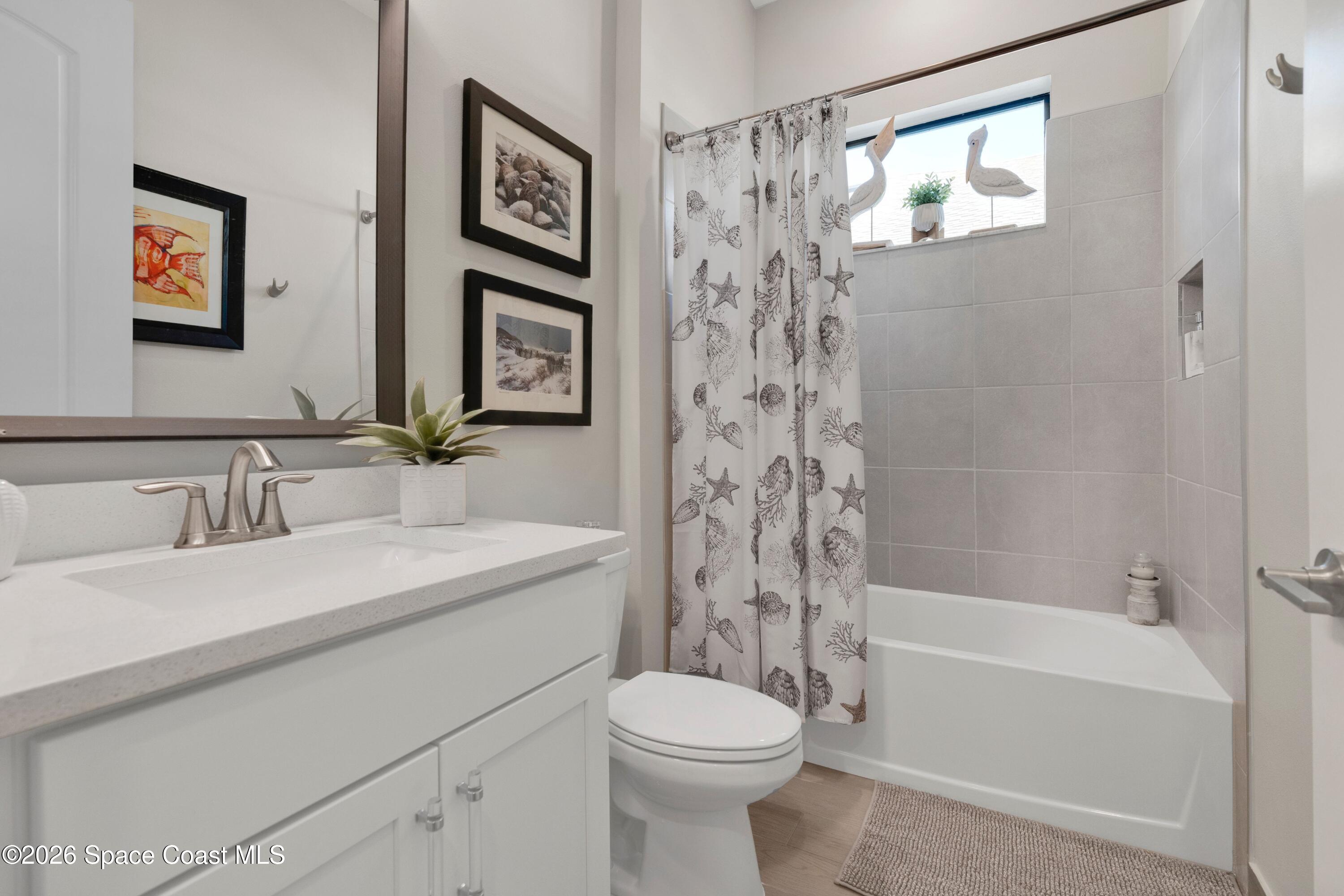 2819 Millennium Circle Melbourne, FL 32940 - Photo 19 of 39 a bathroom with a sink toilet and a bathtub