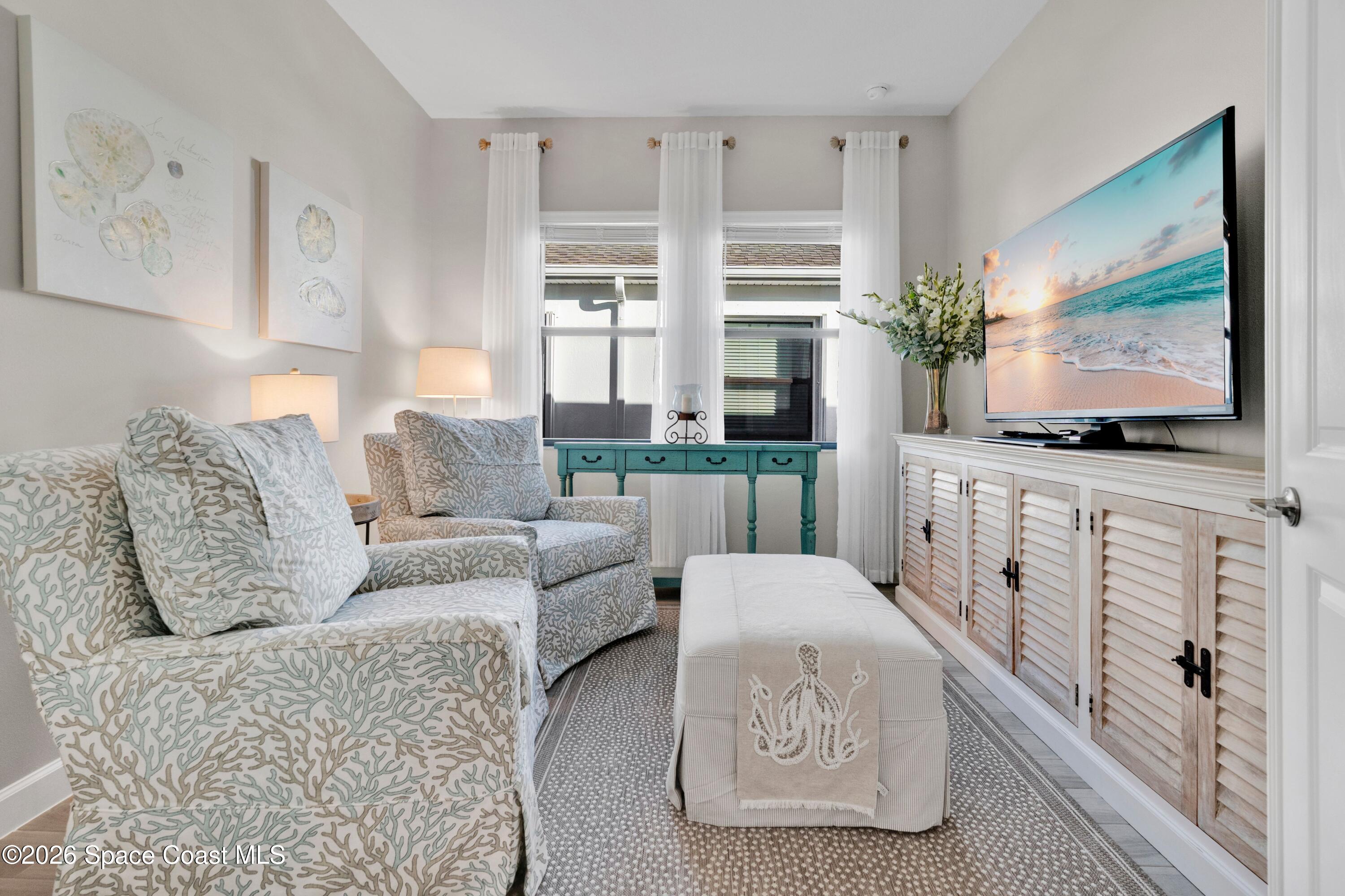 2819 Millennium Circle Melbourne, FL 32940 - Photo 20 of 39 a living room with furniture a flat screen tv and a flat screen tv