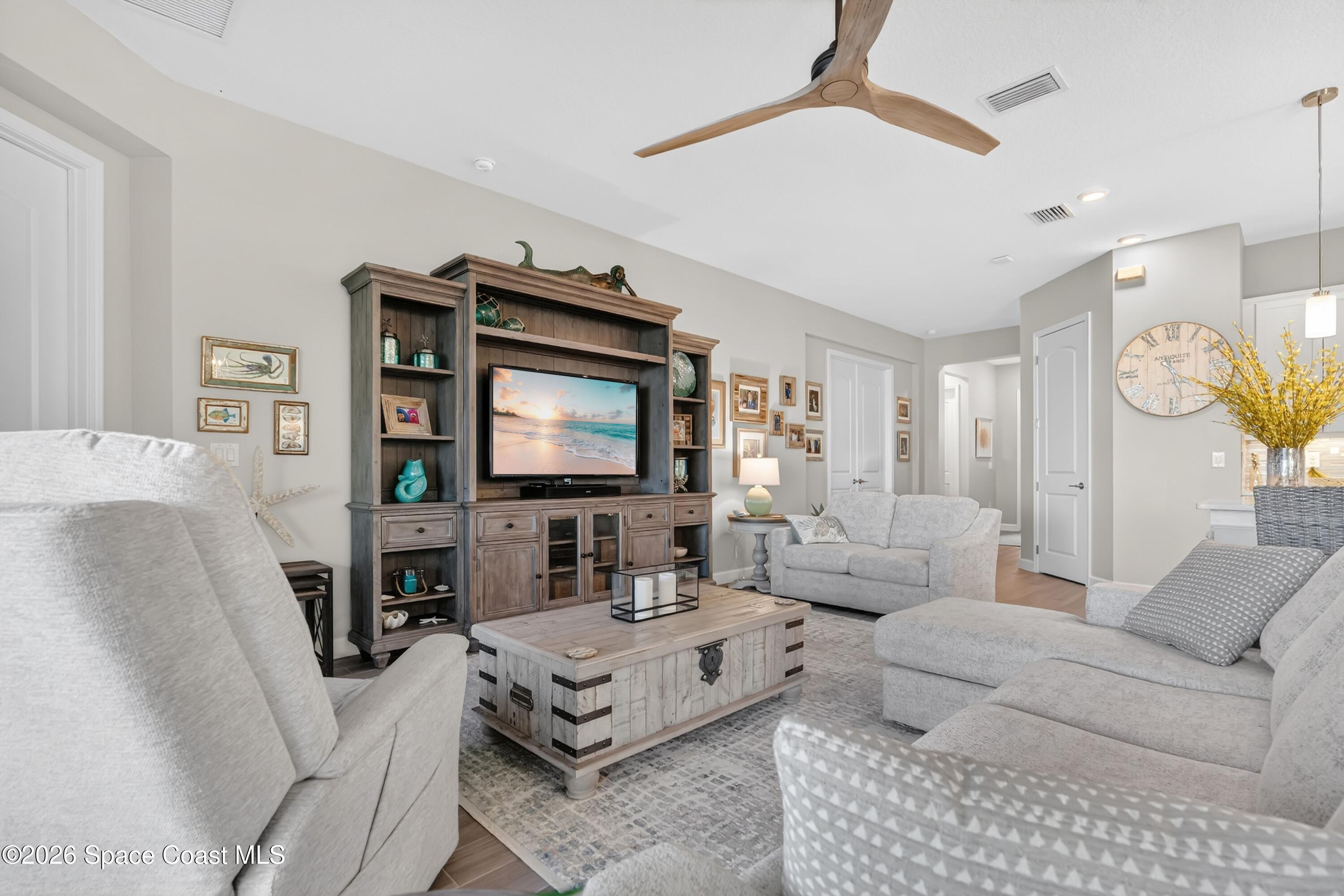 2819 Millennium Circle Melbourne, FL 32940 - Photo 39 of 39 a living room with furniture and a flat screen tv