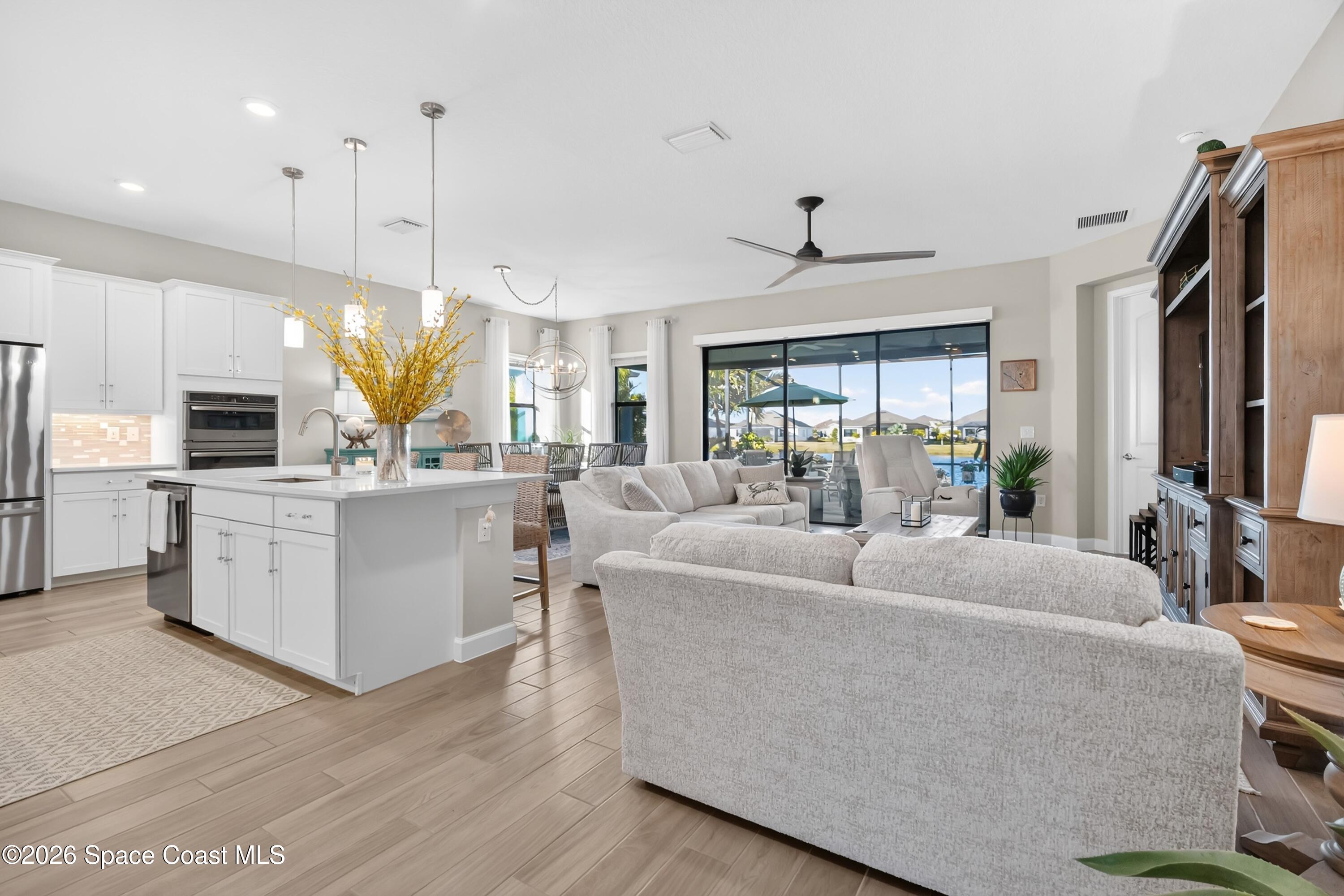 2819 Millennium Circle Melbourne, FL 32940 - Photo 5 of 39 a living room with furniture kitchen area and a large window