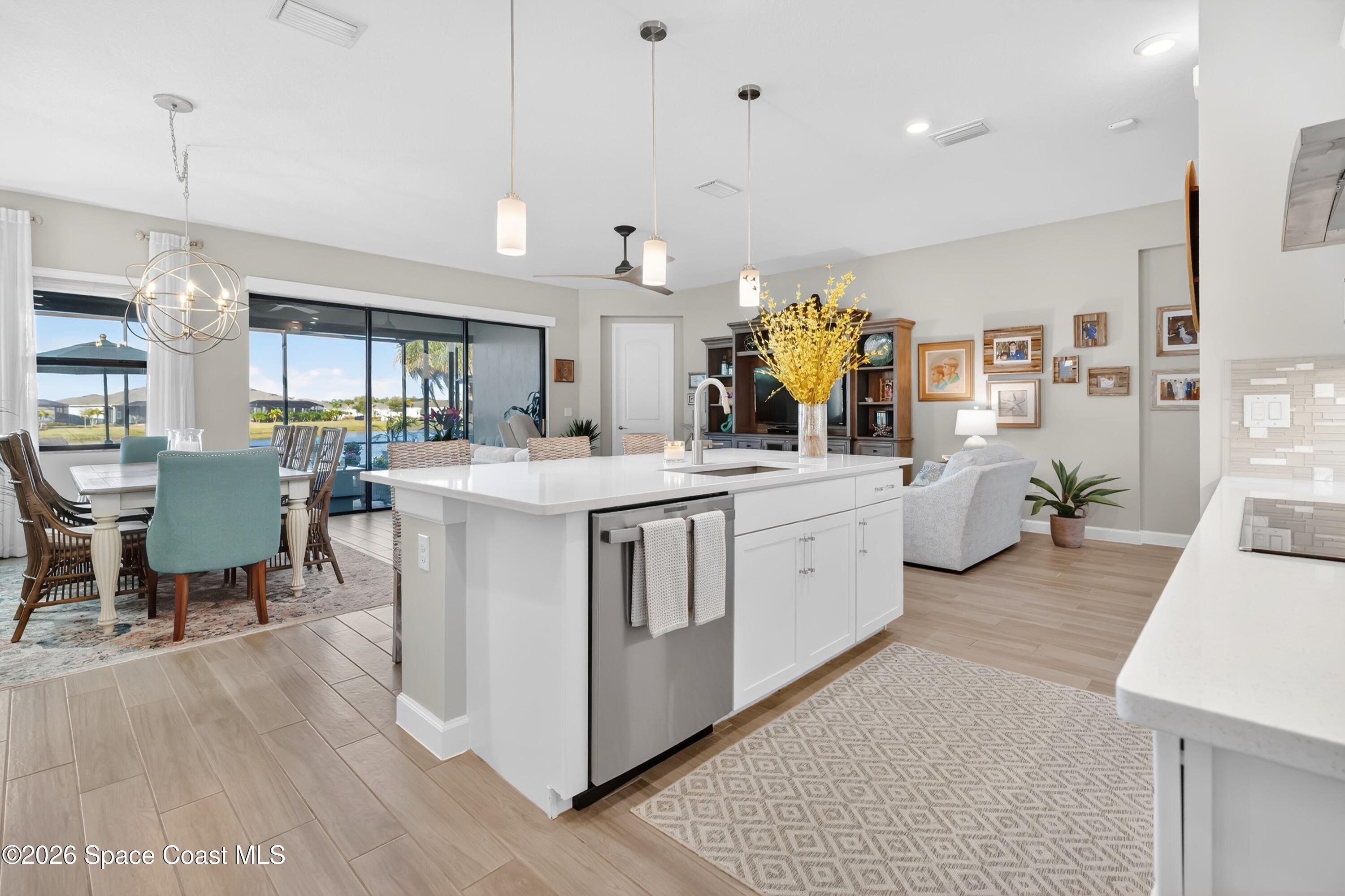 2819 Millennium Circle Melbourne, FL 32940 - Photo 7 of 39 a kitchen with a sink stove and wooden cabinets