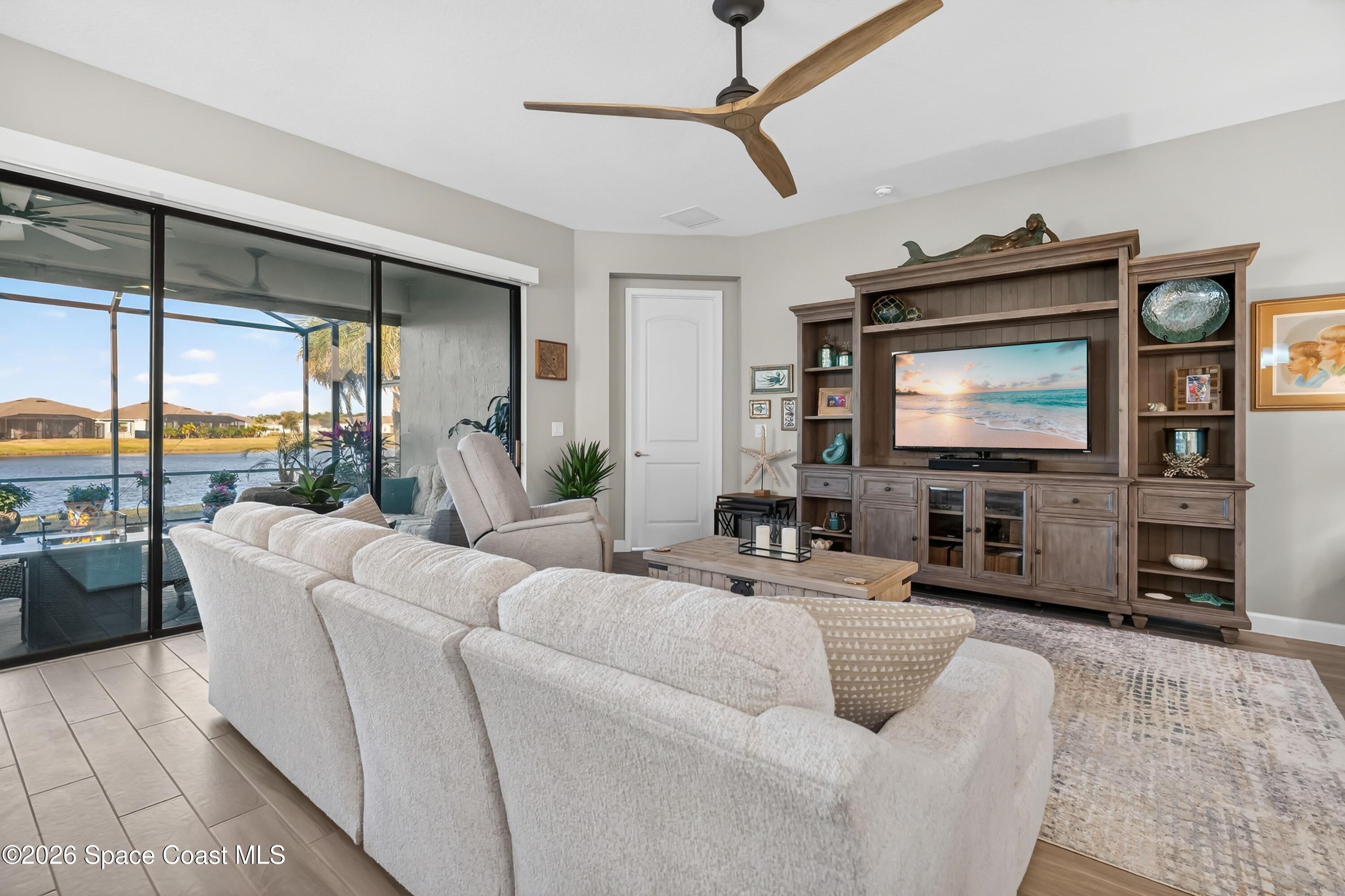 2819 Millennium Circle Melbourne, FL 32940 - Photo 8 of 39 a living room with furniture and a flat screen tv