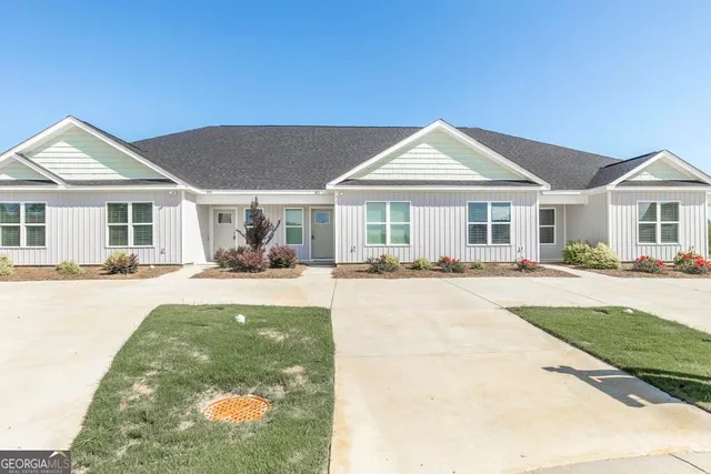 a view of a house with a yard patio and swimming pool