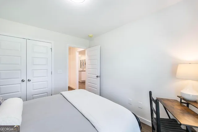 a bedroom with a bed and a chair