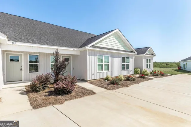 a front view of house with yard outdoor seating and barbeque oven