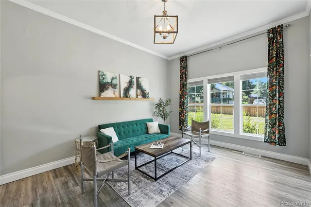 a view of a dining room with furniture and a potted plant