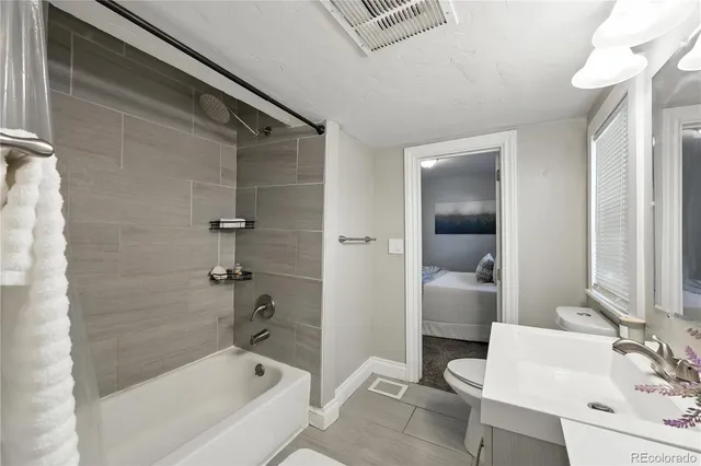 a bathroom with a sink a mirror and a shower