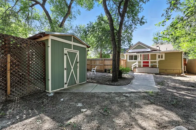 a view of a house with a tree and a yard
