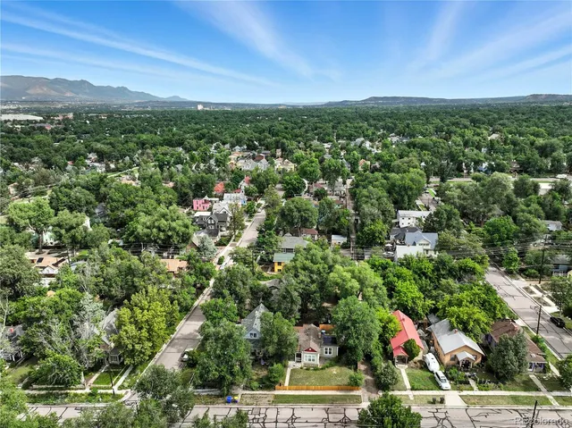 a kitchen with stainless steel appliances granite countertop a stove top oven a sink and dishwasher a refrigerator with wooden floor