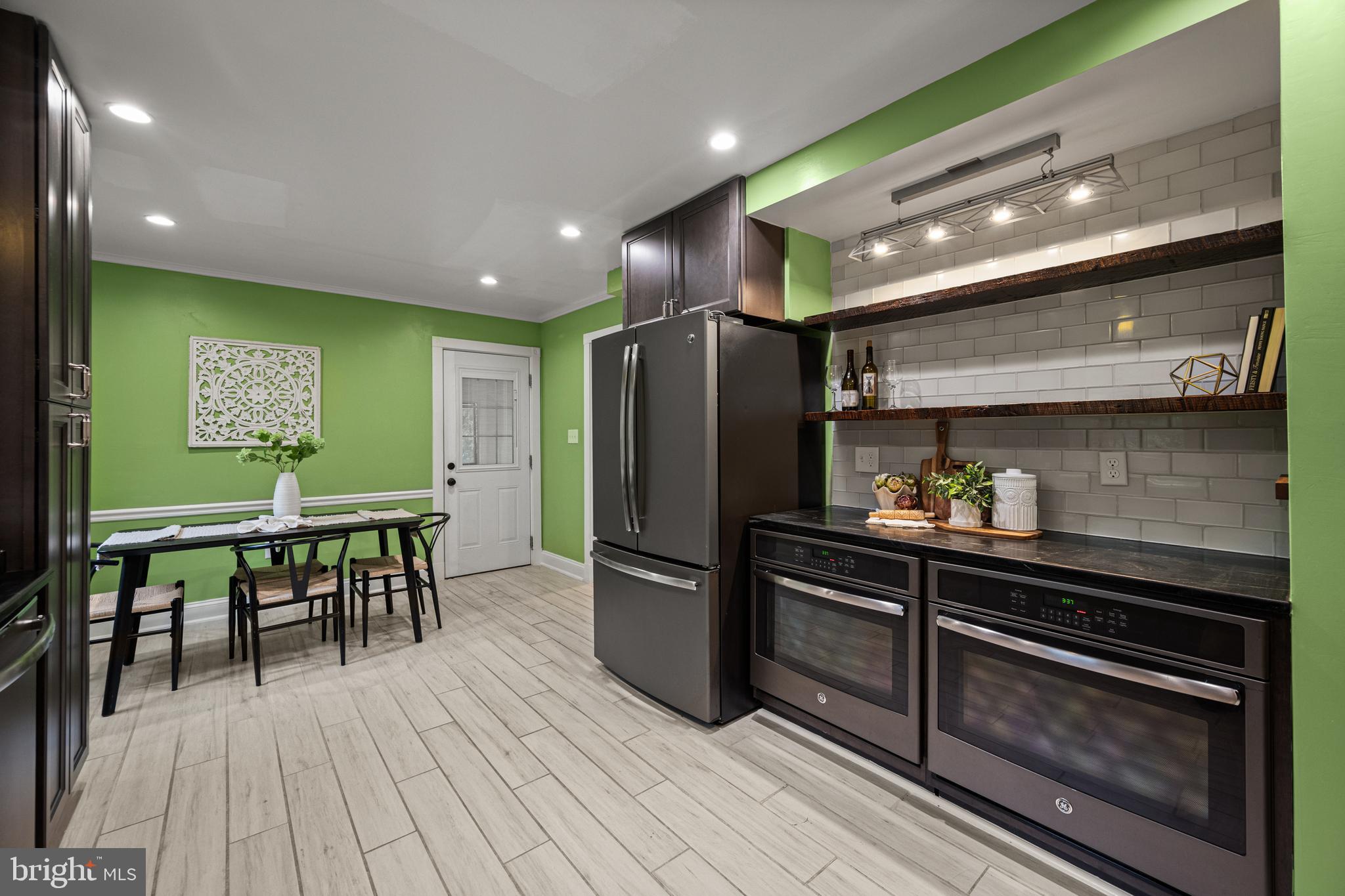10902 Hammond Drive Laurel, MD 20723 - Photo 13 of 48 a kitchen with stainless steel appliances granite countertop a refrigerator a stove and a wooden floors