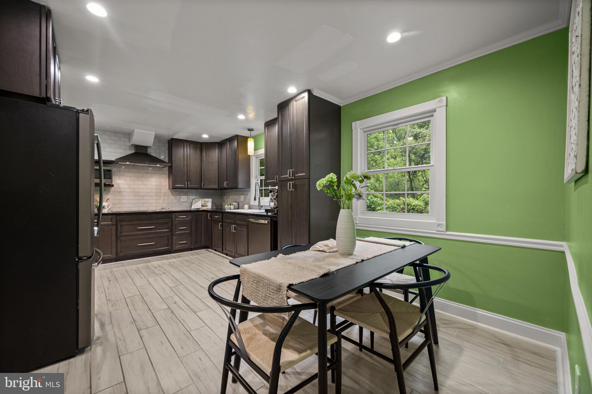 10902 Hammond Drive Laurel, MD 20723 - Photo 15 of 48 a kitchen with a table chairs refrigerator and cabinets