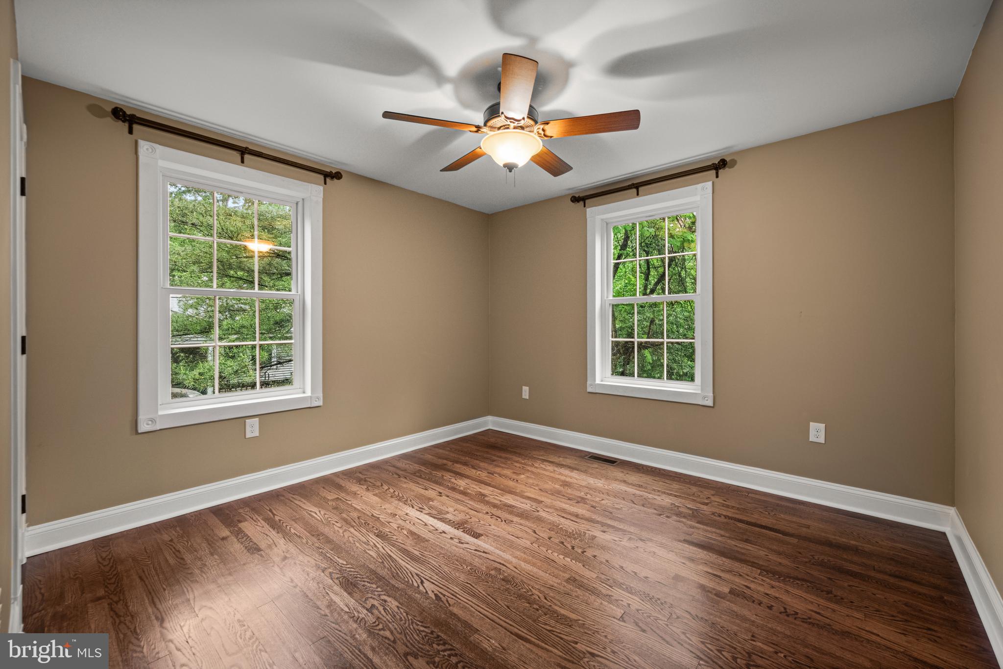 10902 Hammond Drive Laurel, MD 20723 - Photo 26 of 48 a view of an empty room with wooden floor and a window