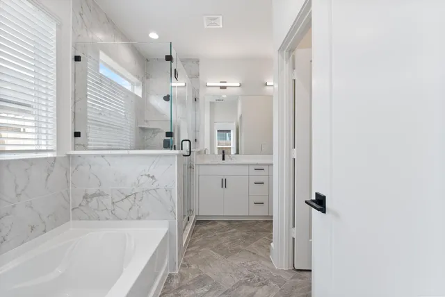 a bathroom with a bathtub and a sink