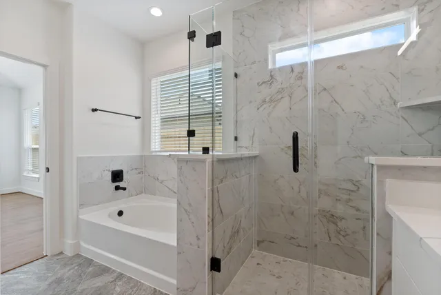 a bathroom with a bathtub and a shower