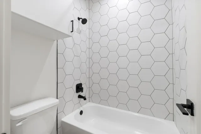 a bathroom with a bathtub and a toilet