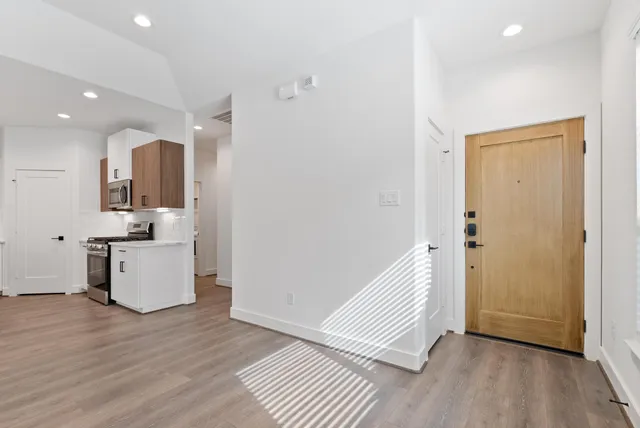 a view of a kitchen with wooden floor and electronic appliances