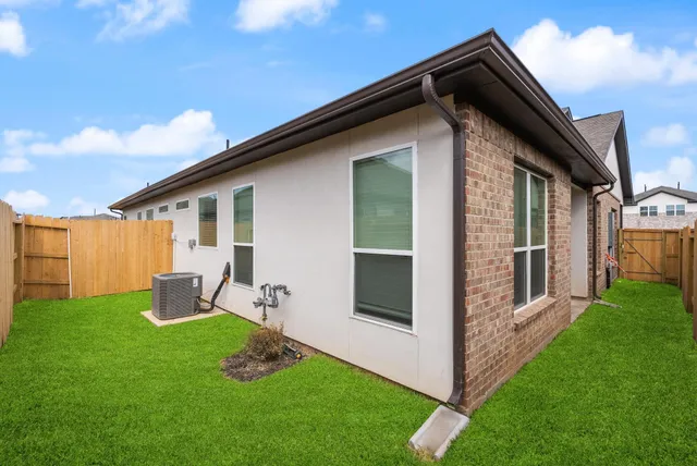 a backyard of a house with table and chairs