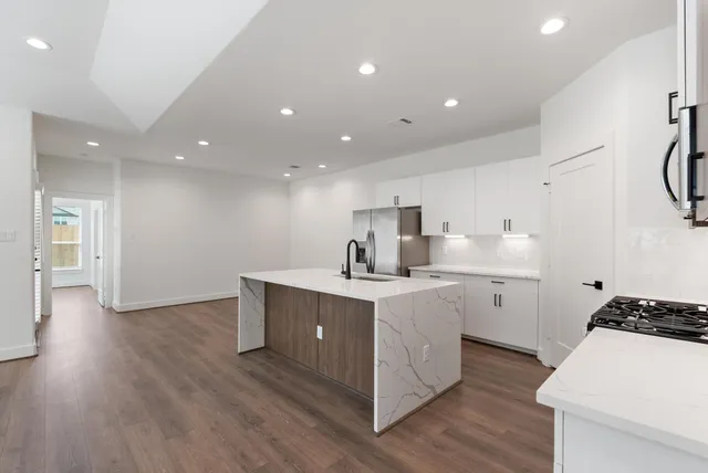 a kitchen with a sink stainless steel appliances and cabinets