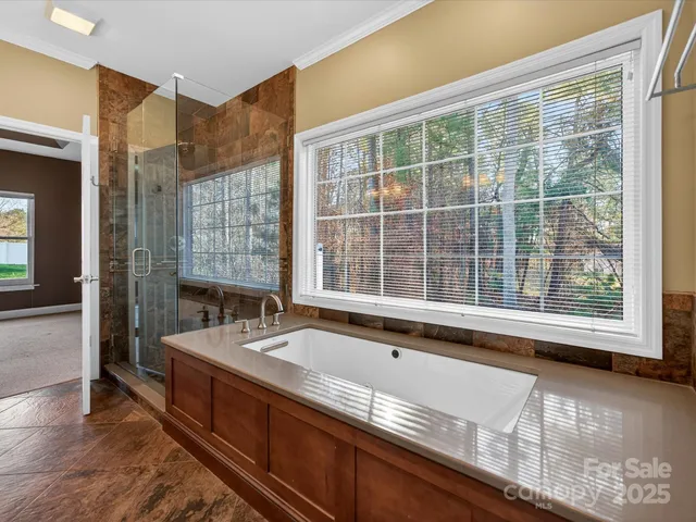 a living room with large window and furniture