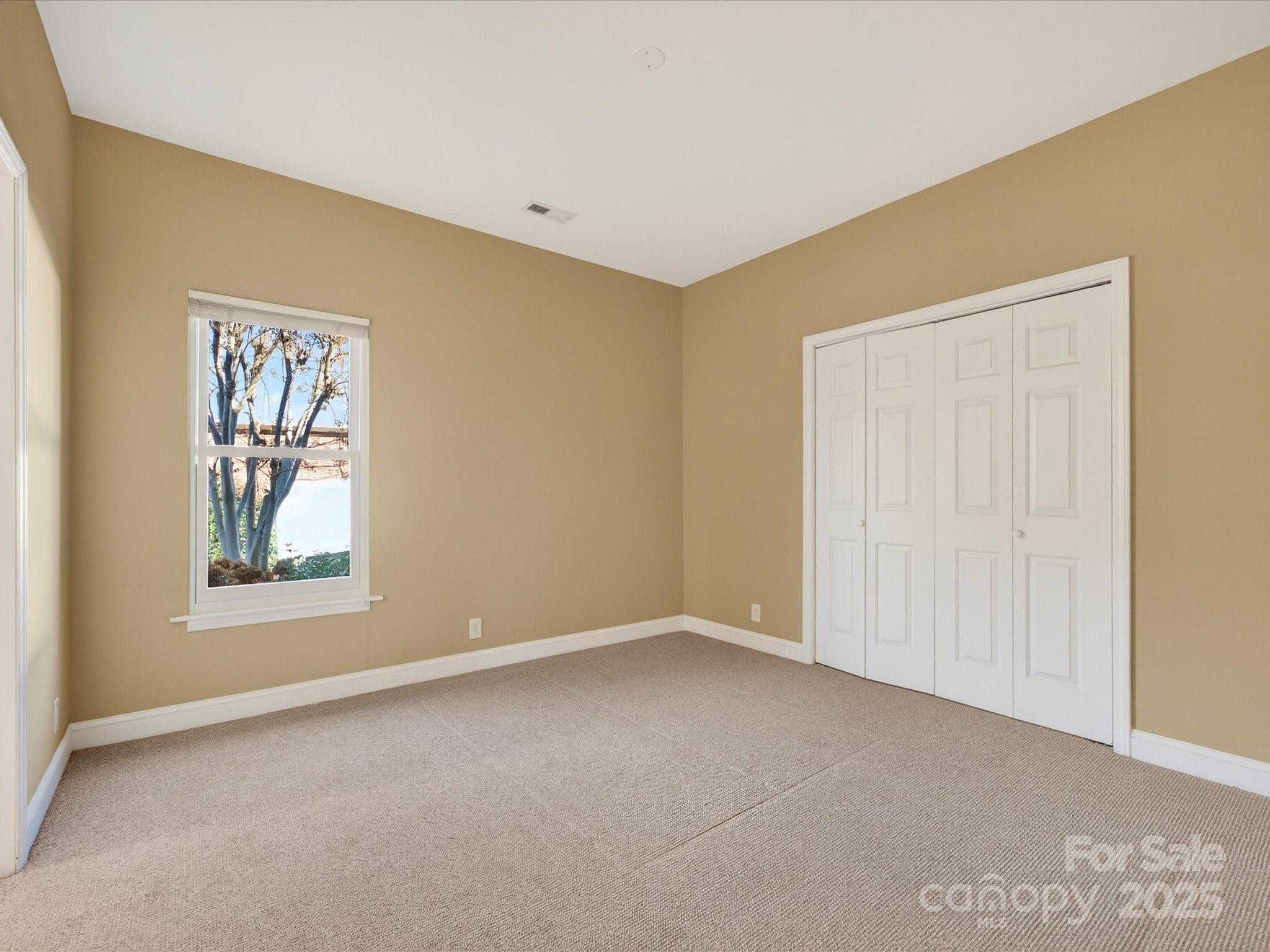 153 Collingswood Road Mooresville, NC 28117 - Photo 15 of 28 an empty room with windows and closet