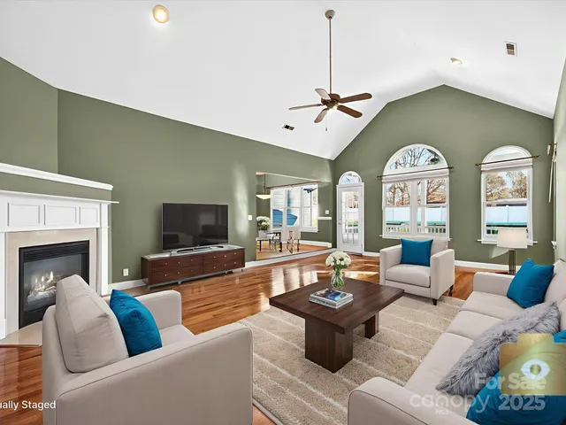 a living room with furniture a fireplace and a flat screen tv