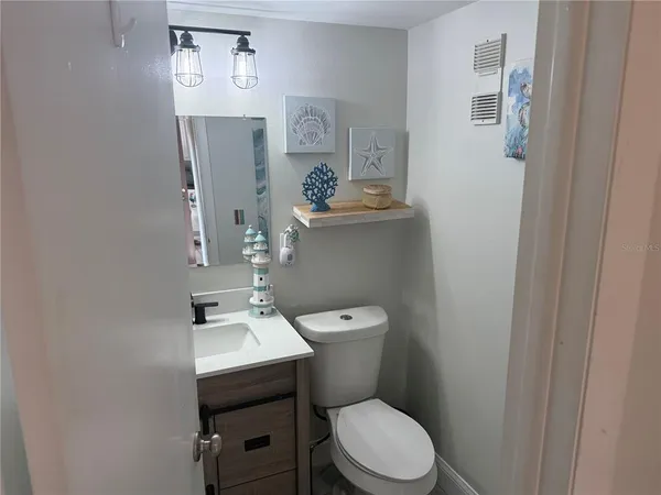 a bathroom with a toilet a sink and mirror