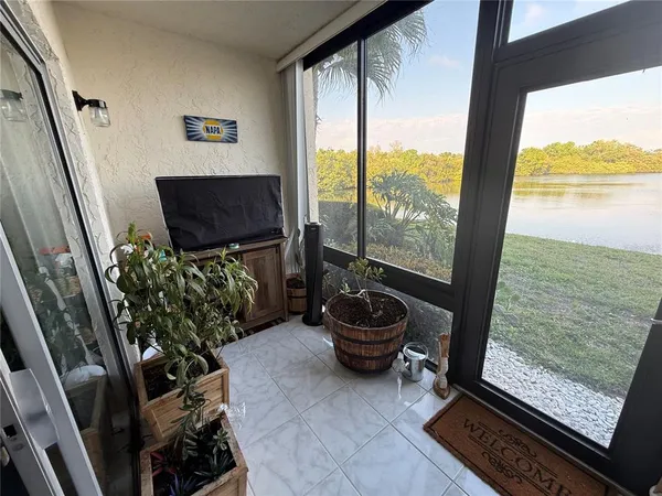 a living room with furniture and a floor to ceiling window