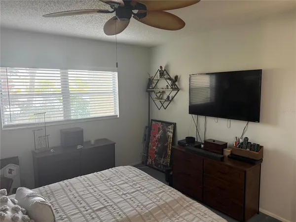 a bedroom with a bed and a flat screen tv