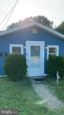 a view of a brick house next to a yard