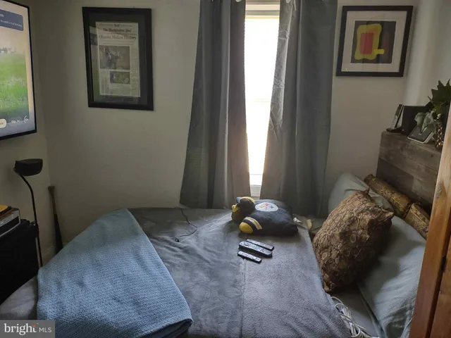 a bedroom with a bed and dresser