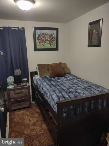 a view of backyard and wooden fence